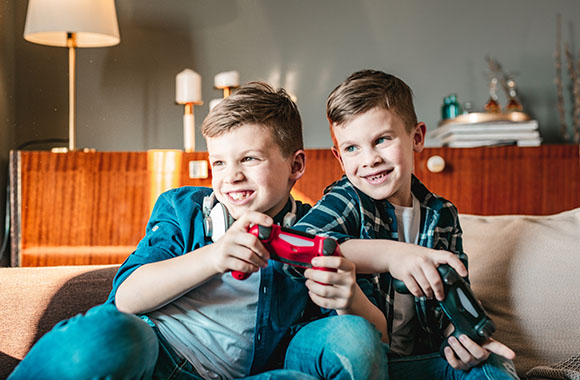 Videogames voor kinderen – Twee jongens spelen samen met de console. Videogames voor kinderen – Twee jongens spelen samen met de console.