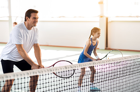 Kind en trainer bij de tennisles. Kind en trainer bij de tennisles.