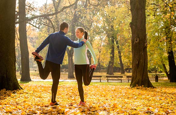 Running in autumn: Two runners do their cool-down in the park.