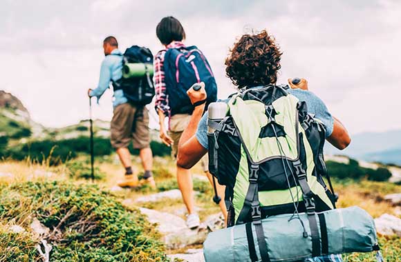 Hiking group walks along a rocky path.