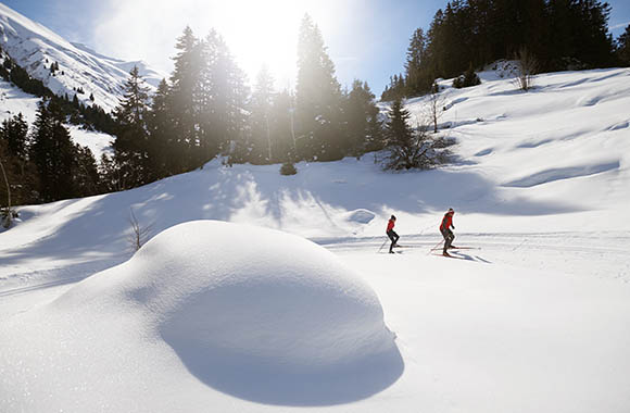 Zwei Langläufer im verschneiten Tal. Zwei Langläufer im verschneiten Tal.
