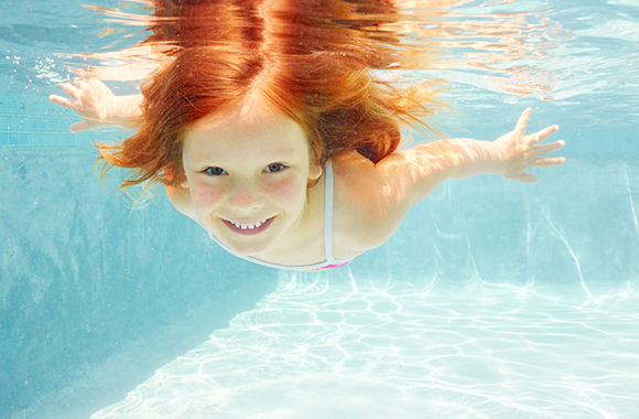 Girl dives in the swimming pool. Girl dives in the swimming pool.
