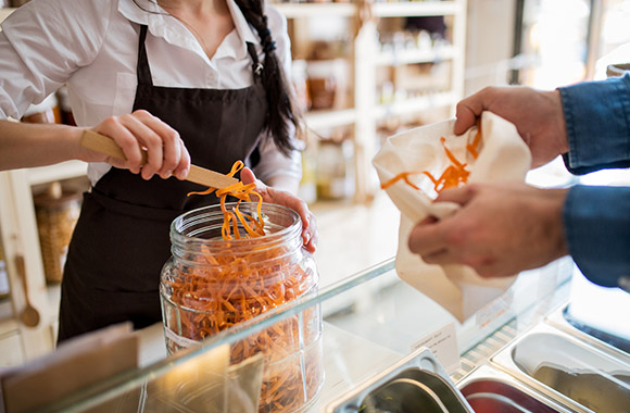 Customer buying food in a zero-waste shop.