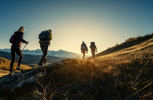 Hiking group walking on a path in the valley.