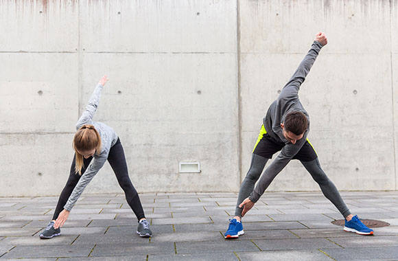 Warm-up exercises - running partners warm-up together.