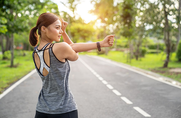 Stretching exercises - woman during cool-down after a run.