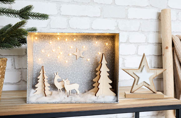 DIY craft idea for children: Christmas landscape with a starry sky from an old cardboard box.