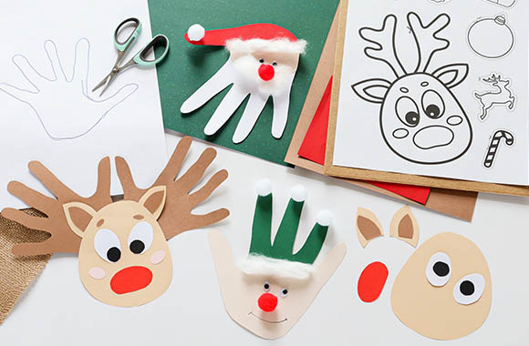 Christmas crafts for kids: craft materials and finished Christmas figures made from handprints.