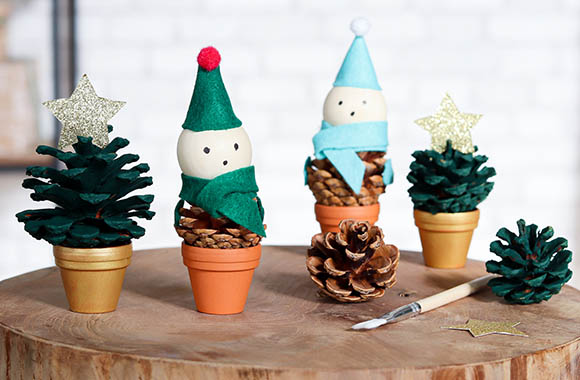 Homemade Christmas trees and Christmas elves on painted and pasted pinecones.