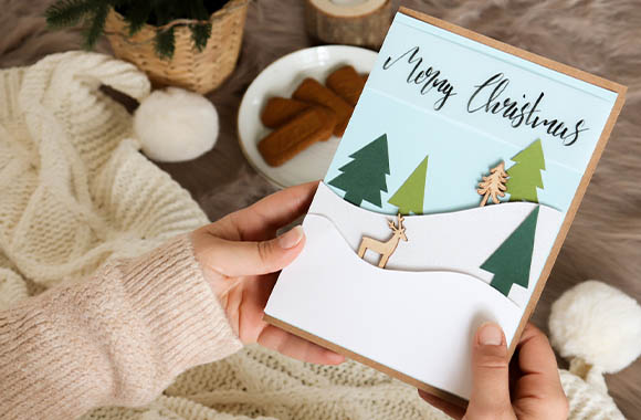 A craft idea - Winter Wonderland Christmas card with a snowy landscape and decorative elements made of wood.