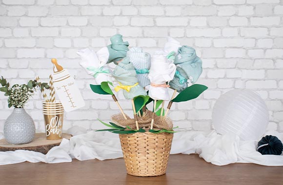 Flowers made from rolled-up clothes in a plant pot.