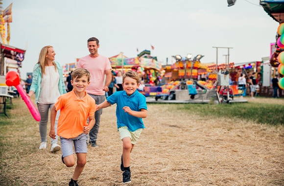 Family-friendly festival: a family visiting a folk festival. Family-friendly festival: a family visiting a folk festival.