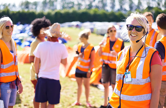 Festival health and safety: festival members of staff wearing high-visibility waistcoats securing an event. Festival health and safety: festival members of staff wearing high-visibility waistcoats securing an event.