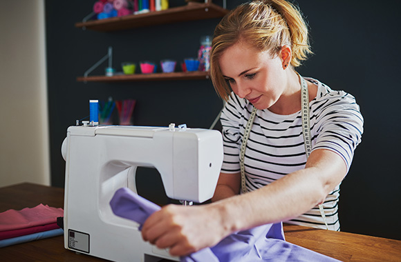 Sewing for beginners: A hobby sewer works with her sewing machine. Sewing for beginners: A hobby sewer works with her sewing machine.