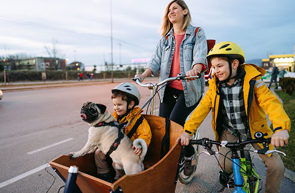 Cómo llevar niños en bicicleta: una madre lleva a uno de sus hijos en una cargo bike.