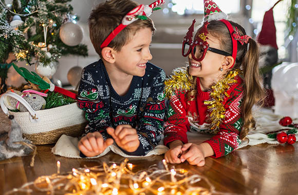 New Year’s Eve Games Kids: Two siblings dressed up for New Year’s Eve. New Year’s Eve Games Kids: Two siblings dressed up for New Year’s Eve.