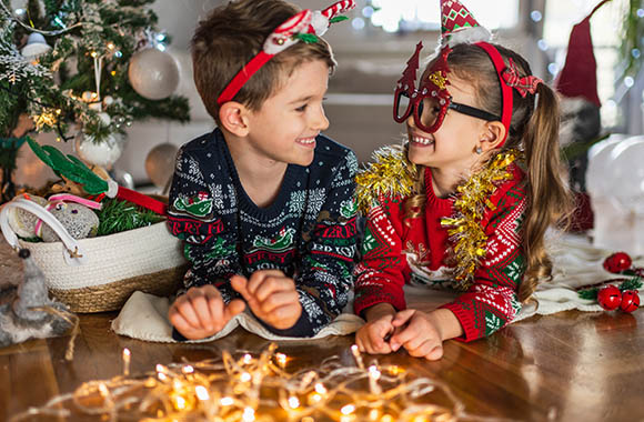 New Year’s Eve Games Kids: Two siblings dressed up for New Year’s Eve.