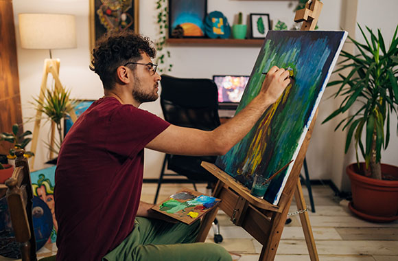 A man paints an abstract painting.