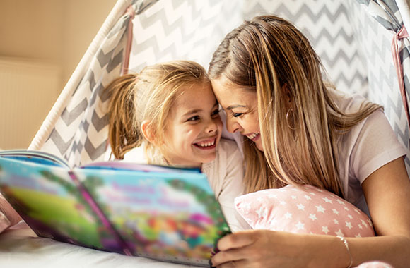 Moeder en dochter lezen een boek. Moeder en dochter lezen een boek.