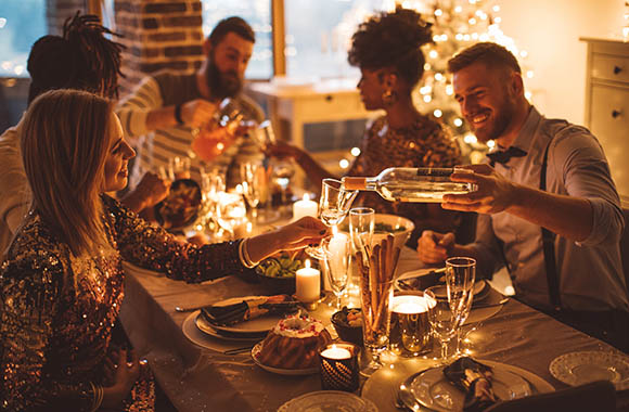 New Year’s Eve ideas: A group of friends at a New Year’s Eve dinner.