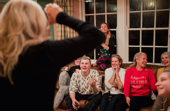 New Year’s Eve charade: woman acts out a term. New Year’s Eve charade: woman acts out a term.