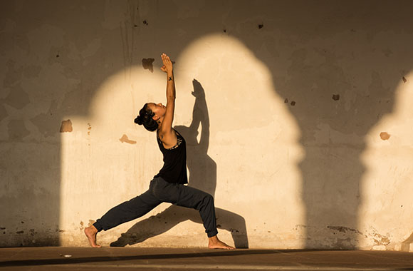 Yoga philosophy - woman practising yoga in New Delhi.