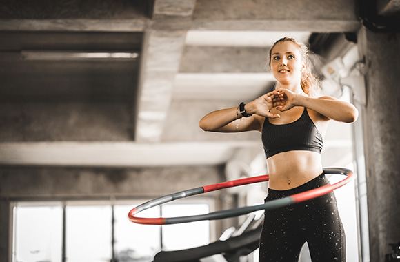 Hula hoop – woman training with a hula hoop.