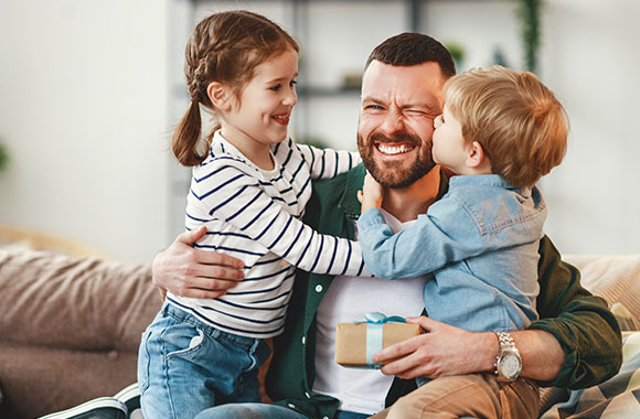 Children present their father with a Father's Day gift. Children present their father with a Father's Day gift.