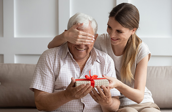 Last-minute gift for Father's Day - adult daughter gives her father a gift. Last-minute gift for Father's Day - adult daughter gives her father a gift.