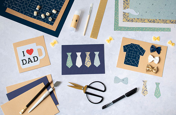 Making a Father's Day card: craft materials for Father's Day cards on a table. Making a Father's Day card: craft materials for Father's Day cards on a table.