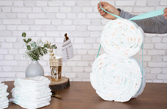 Ourson en couches: les différentes parties de l'ourson en couches sont reliées par un ruban en tissu assorti. Ourson en couches: les différentes parties de l'ourson en couches sont reliées par un ruban en tissu assorti.