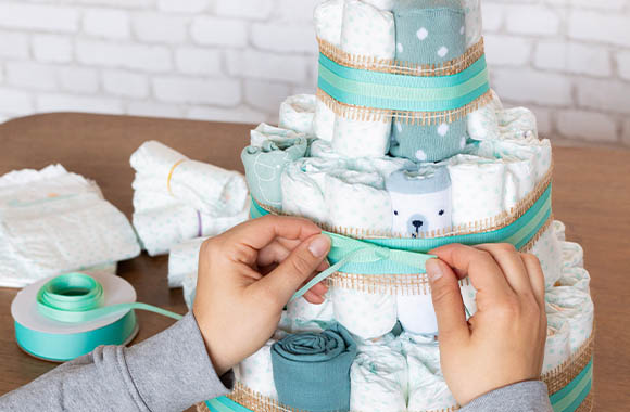 Decorate the nappy cake with pretty bows.