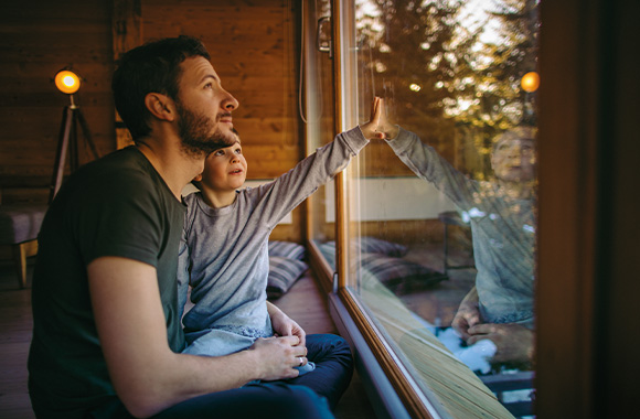 Sustainable accommodation: a father and son spending their holiday in a holiday home. Sustainable accommodation: a father and son spending their holiday in a holiday home.