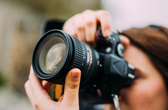 The ideal camera for beginners – an amateur photographer taking photos with her first camera. The ideal camera for beginners – an amateur photographer taking photos with her first camera.