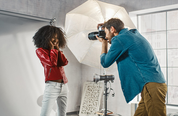 Fashion photography – a model wearing a red leather jacket for a fashion photo shoot.