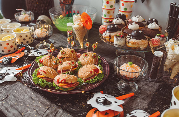 Halloween recipes: Halloween themed food and snacks on a table. Halloween recipes: Halloween themed food and snacks on a table.