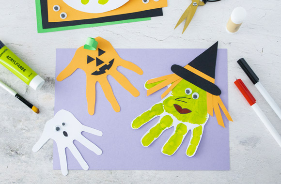 Making Halloween window decorations: Halloween decorations made from cut-out handprints.