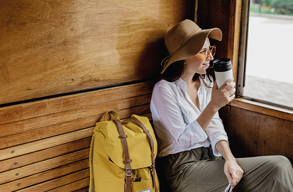 Travelling light: tourist travelling with a rucksack on a train.