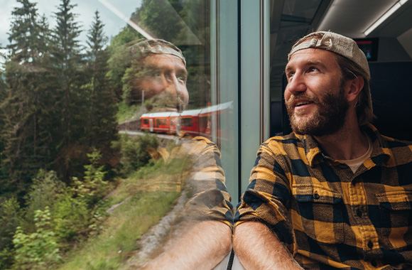 Eco-travel: a man travelling by train Eco-travel: a man travelling by train