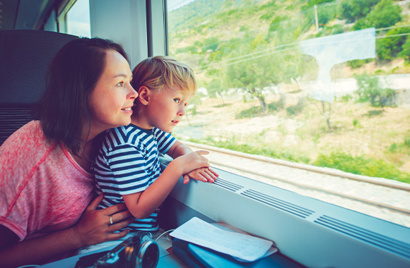 Sustainable modes of transport with children: a mother and son travelling by train. Sustainable modes of transport with children: a mother and son travelling by train.
