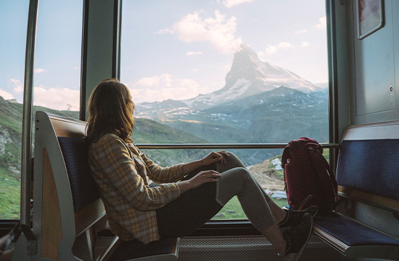 A woman travelling on a train to Switzerland.