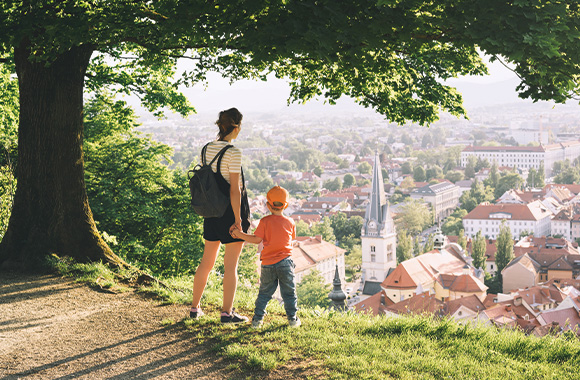 A mother and son taking a small break from walking around the city.