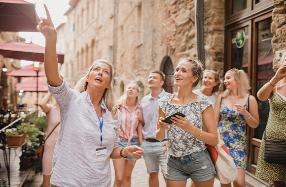Soft tourism: a group of holidaymakers on a city tour in Volterra.
