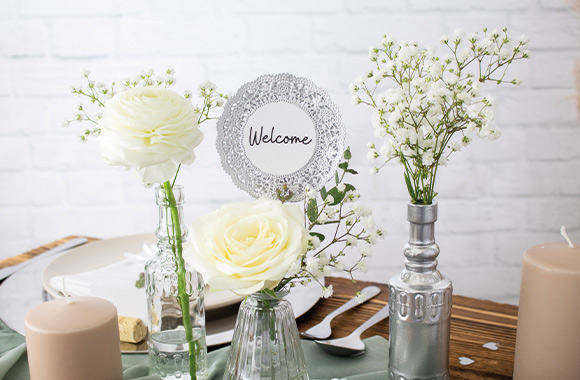 Silver wedding table decoration: finished flower pin stuck inside a vase. Silver wedding table decoration: finished flower pin stuck inside a vase.