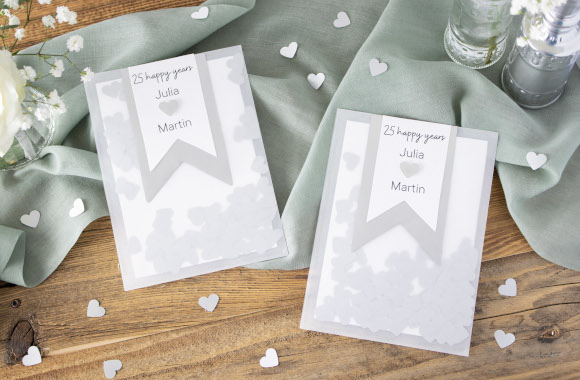 Fun silver wedding invitation: homemade invitation with confetti hearts.