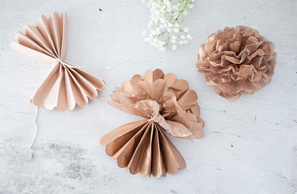 Unique decorations for a handmade silver wedding anniversary gift: paper flowers made from tissue paper.