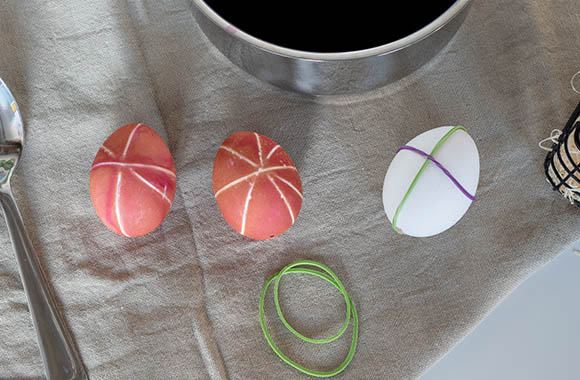 Painting Easter eggs - use rubber bands to create patterns on the egg.