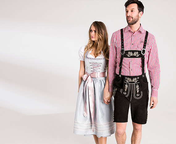 Man en vrouw in lederhose en Dirndl gekleed voor het Oktoberfest.