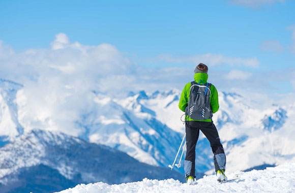 Un skieur de fond admire le paysage enneigé Un skieur de fond admire le paysage enneigé